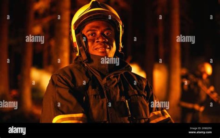 A firefighter looking at a fire.