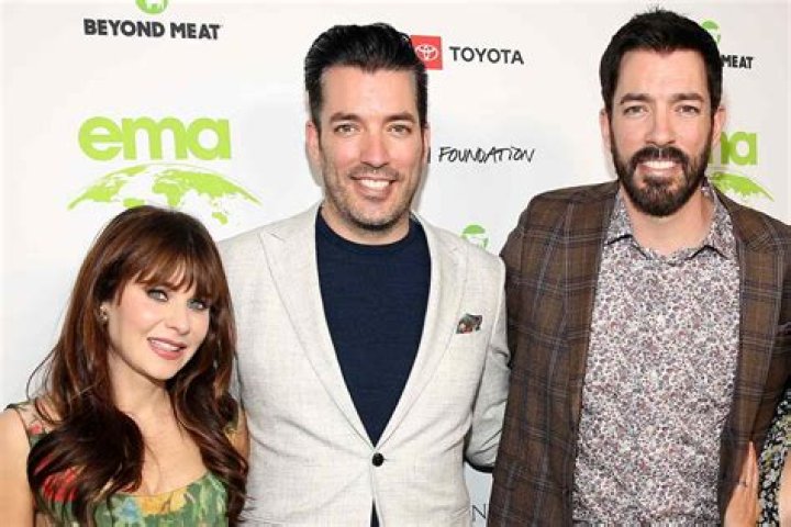 Jonathan Scott. Drew Scott, and LeAnn Rimes posing on 'Celebrity IOU'
