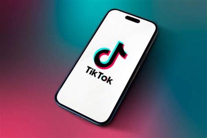 TikTok logo on a phone in a hand.
