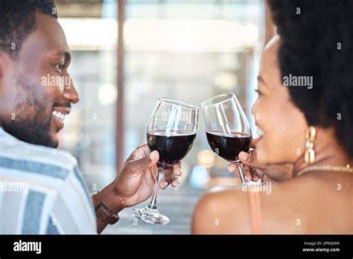 Two Black people drinking wine